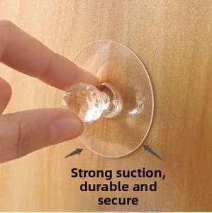 Close-up of clear adhesive screw hook being pressed onto a wood texture surface