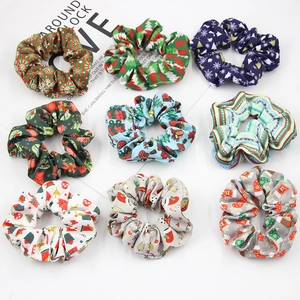 Detailed flat lay of festive Christmas themed fabric scrunchies with holiday patterns