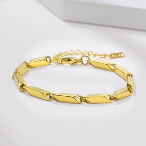 Detailed close-up of golden stainless steel stick chain with K18 tag and lobster clasp