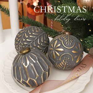 Set of three 8cm dark grey and gold embossed Christmas ornaments displayed in a white tray