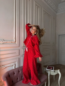 Red heart print pajama set featuring long sleeve lapel top and loose pants on a model