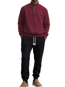 Detail of burgundy knitted men's tracksuit set featuring stand collar and button texture