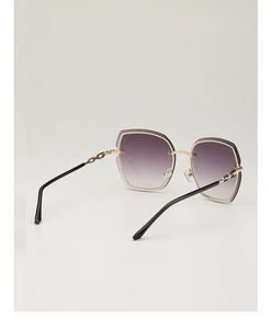 Detail of gradient purple lenses and golden metal chain-textured temples on sunglasses