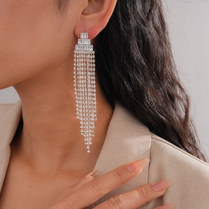 Close-up of model wearing silver zircon triangle long tassel earrings for women