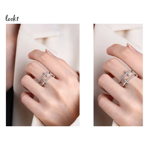 Detail of silver double-layered ring with cross charms and sparkling zircon accents