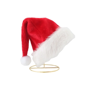 Classic red and white plush Christmas hat with faux fur trim on a gold stand