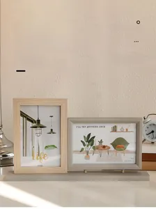 Detail view of 4x6 double wood picture frame set with grey base on a beige desk