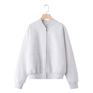 Detail of light gray knitted pilot jacket with silver metal zipper and ribbed texture
