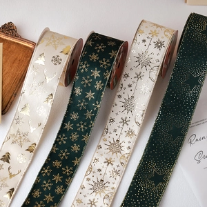 Dark green and cream Christmas ribbons with gold snowflakes and reindeer patterns