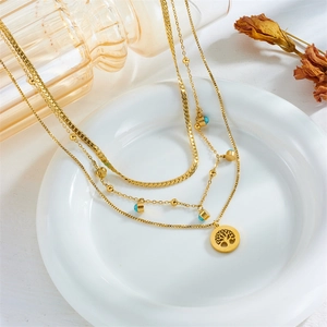 Layered gold tree of life necklace with flat snake chain and blue turquoise stone