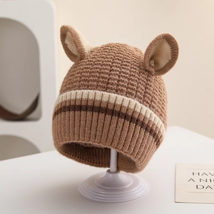 Detail of baby striped knit beanie with cute animal ears and soft waffle texture