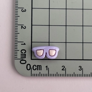 Miniature purple resin sunglasses accessory for nail art and DIY crafts on a measurement mat