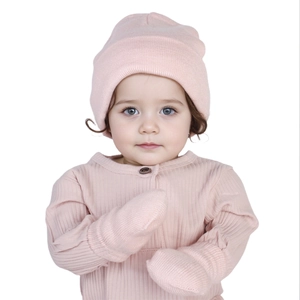 Detail of light pink baby knitted beanie and mittens set showing soft wool texture