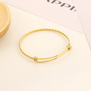 Minimalist golden stainless steel twisted cable bracelet with adjustable open cuff design