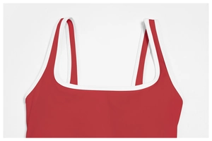 Detail of red yoga bodysuit with white contrast piping and elegant square neckline