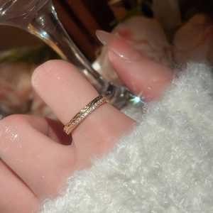 Close-up of elegant 18k gold plated adjustable ring with pavé zircons on finger