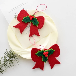 Christmas red felt bow ornaments with green holly leaves and red berries for tree decoration