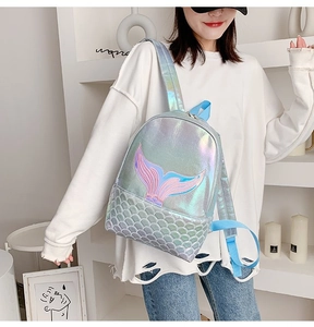 Close-up of holographic mermaid tail embroidery and scale texture on silver backpack