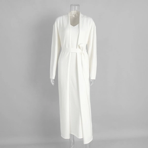 Detail of white knit three-piece set featuring long cardigan and v-neck maxi dress with belt