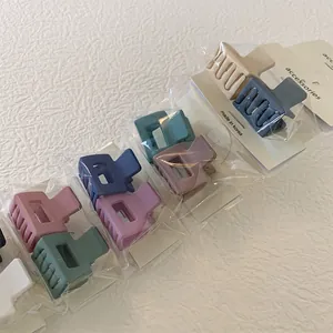 Close-up of matte Morandi square hair claws in assorted pastel colors on display cards
