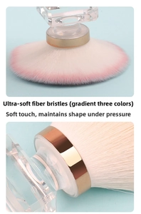 Close-up of soft gradient pink powder brush head with crystal handle and gold ferrule detail