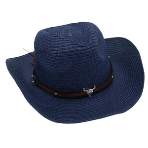 Detail of navy woven cowboy hat featuring brown leather band and silver bull skull ornament