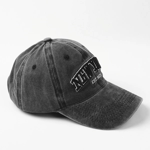 Detail of vintage washed cotton baseball cap featuring high-quality white embroidery text