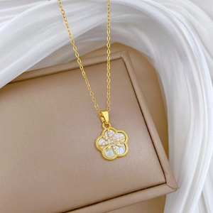 Elegant gold flower necklace with white shell petals and sparkling zircon stars