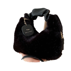 Plush black faux fur handbag featuring soft texture and stylish pleated top handle
