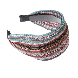 Colorful striped woven headband with wide vintage design on a clean white background