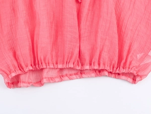 Detail of pink pleated fabric texture with elastic ruffled hem on bohemian style outfit