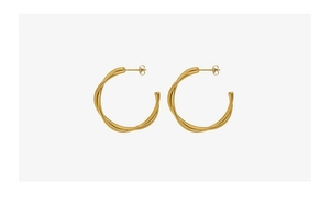 Close-up of golden double-layer twisted hoop earrings in minimalist titanium steel