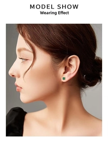 Model wearing vintage emerald cut green stone stud earrings with gold plating