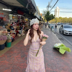 Pink plaid two-piece set featuring backless camisole and ruffled skirt in street setting