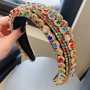 Close-up of luxury Baroque headband with multicolored rhinestones on gold base and velvet