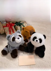 Plush panda, capybara, and raccoon toys on soft carpet with festive gift boxes