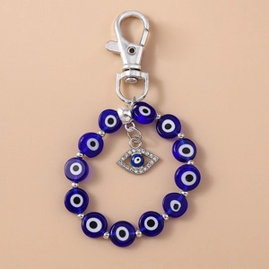Close-up of blue Evil Eye beaded keychain with sparkling crystal rhinestones and metal clasp