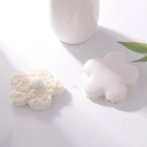 Close-up of cream white teddy velvet flower accessories with soft plush texture details