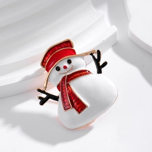 Cute Christmas snowman brooch with red enamel hat and scarf on a white decorative stand