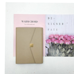 Detail of premium khaki lychee grain leather notebook cover with a gold square buckle