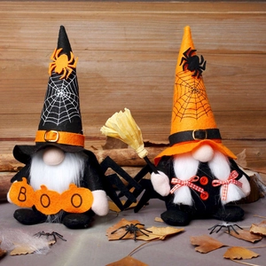 Pair of Halloween plush gnomes with wizard hats and spiders on vintage wood background