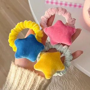 Set of four colorful plush star scrunchies in velvet fabric for cute hair styling
