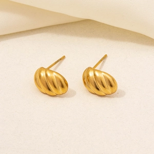 Macro detail of textured 304 stainless steel gold stud earrings with ribbed design