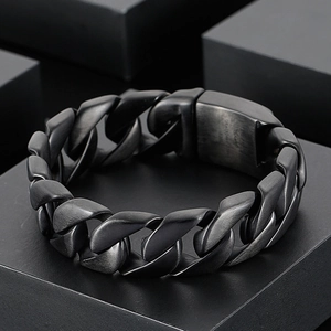 Matte black 316L stainless steel Cuban chain bracelet for men on geometric stand