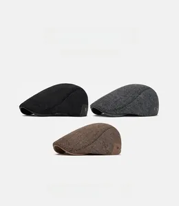 Detailed texture of newsboy caps in black, grey herringbone, and brown tweed wool fabrics