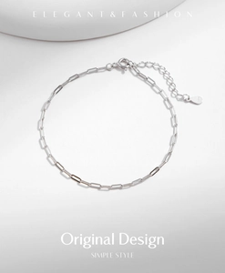 Macro detail of S925 sterling silver paperclip chain with hallmark tag and clasp
