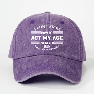 Close-up of washed purple cotton baseball cap with white Slogan text on the front