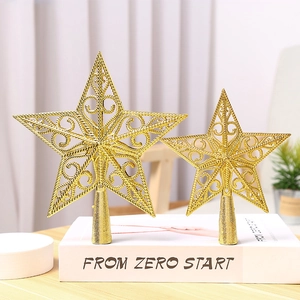 Golden hollow star Christmas tree topper with conical base on a decorative book