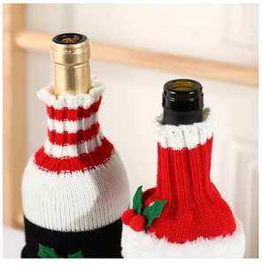 Detail of knitted Santa wine bottle covers with faux fur trim and holly berry accents
