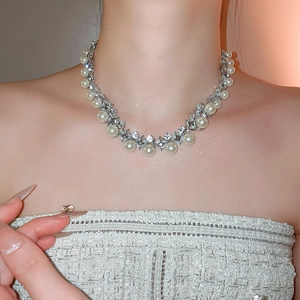 Detail of diamond rhombus pearl necklace on model with elegant vintage french style